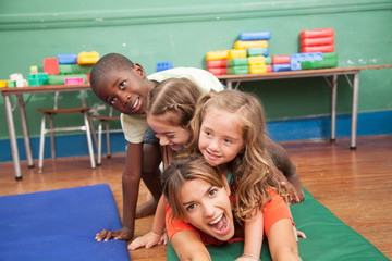 teacher with hers students playing on the floor