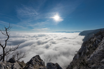 Aerial view of the sky and fog a from a plateau on a mountain