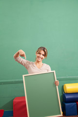 teacher holding a blackboard