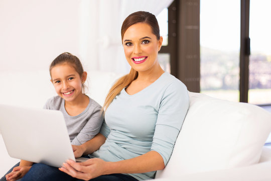 young woman and daughter with laptop