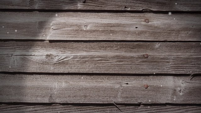 Loop with weathered wood and falling snow