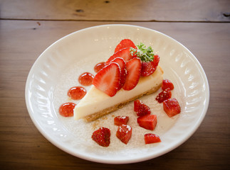 Delicious cheesecake with berries on table close up