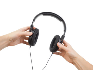 Headphones in hands on a white background