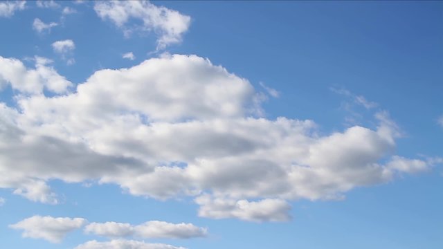 Loop features time lapse motion clouds backed by a beautiful blue sky.