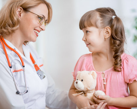 Pediatrician doctor talking with kid