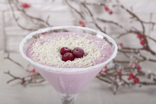 Smoothies with cranberries and white chocolate in a glass with f