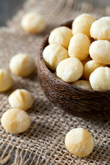 salted macadamia nuts on wooden surface