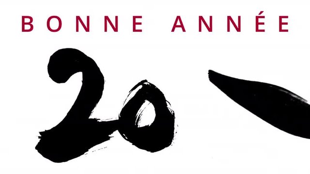 Happy New Year 2016 in several languages - writing calligraphy with a brush chinese ink - highly contrasted - greeting video card with wishes appearing on the top.