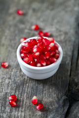 pomegranate seeds on wooden surface
