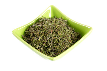 dried thyme in a bowl over white