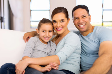 family of three sitting on the couch