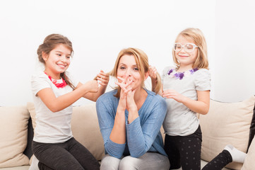 Mother and young daughters having fun at home