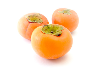 Japanese Persimmon on White Background. Selective Focus on the Front