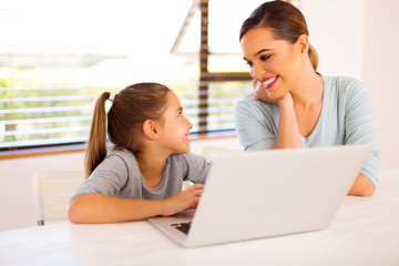 daughter using laptop computer with her mother
