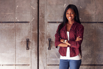 Portrait Of Female Designer Standing In Modern Office