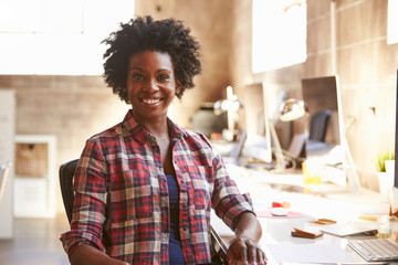 Portrait Of Female Designer Working At Desk In Modern Office