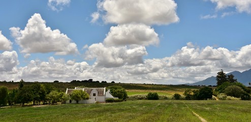 Fototapeta na wymiar Landscape with Farm House and clouds in the sky