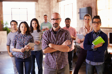 Portrait Of Staff Standing In Modern Design Office