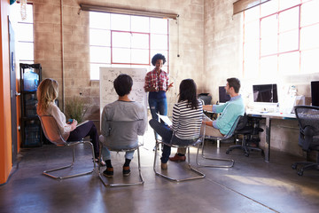 Fototapeta premium Group Of Designers Having Brainstorming Session In Office
