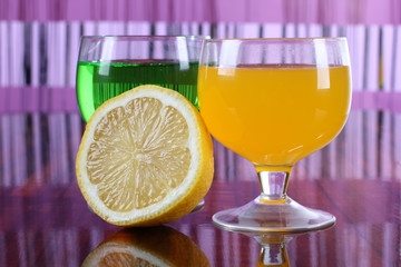 Glass jars with colorful cocktails on table