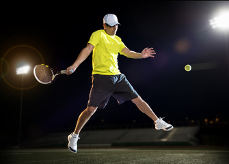 Fototapeta na wymiar Tennis player at night
