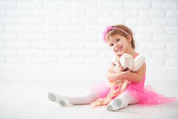 Fototapeta premium little child girl dreams of becoming ballerina with ballet shoe
