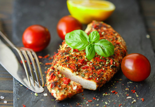 Chicken Fillet With Tomato And Basil On Black Plate