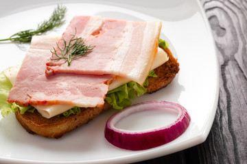 sandwich with bacon and lettuce on a white plate