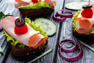 sandwiches on black table close up