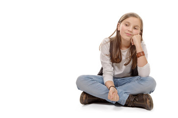 young teenager sitting cross-legged on the floor on white