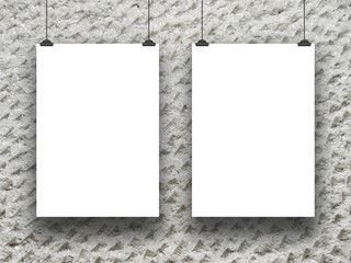 Close-up of two white paper sheet frames on grey concrete wall background