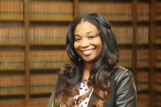 Young attractive female African American lawyer in law library