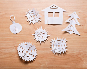 Paper snowflakes and other decoration on table