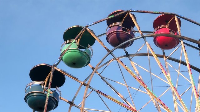 amusement park carousel big wheel on blue sky