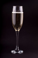 A glass of champagne on black background