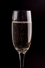 A glass of champagne on black background