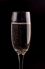 A glass of champagne on black background