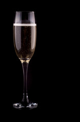 A glass of champagne on black background