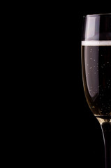 A glass of champagne on black background