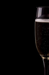 A glass of champagne on black background