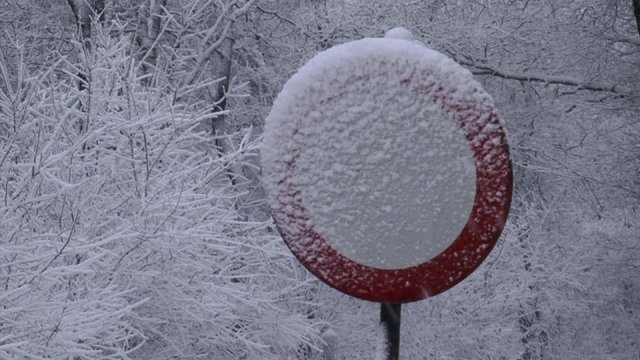 Road traffic sign, road closed in snowstorm 