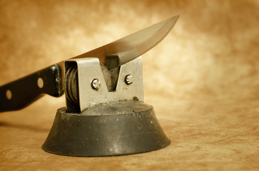Old kitchen knife and sharpener