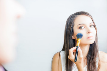 makeup artist woman doing make-up using cosmetic brush for yourself