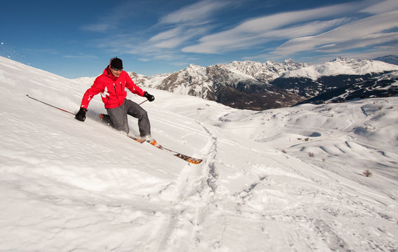 Young man skiing in powder snow