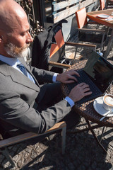 Middle-aged man , handsome and elegant working outside the office in a relaxed and sunny atmosphere