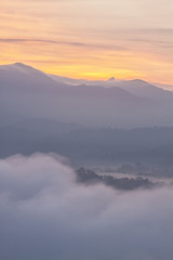 layers of mountain with golden sky