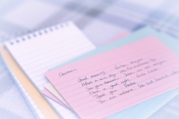 German; Learning New Language Writing Greetings on the Notebook