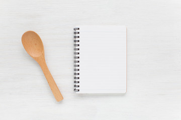 Empty notebook and kitchen utensils for food recipes..