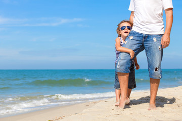 Father and son playing on the beach at the day time.