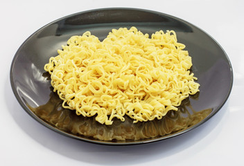 The half egg noodles is in a black dish